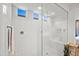 A glass enclosed shower with white tile and modern fixtures, including a convenient built-in bench at 22849 E Marsh Rd, Queen Creek, AZ 85142