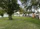 Lush backyard featuring a well-maintained lawn, a patio area, and a contemporary white house exterior at 2311 E Colter St, Phoenix, AZ 85016