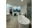 Bright bathroom with a soaking tub, double vanity, marble accents, and a walk-in closet at 2311 E Colter St, Phoenix, AZ 85016