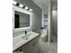 Modern bathroom with a stylish vanity, a backlit mirror, and a tiled walk-in shower at 2311 E Colter St, Phoenix, AZ 85016