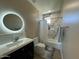 This bathroom has a modern shower tub and a large circular vanity mirror with light at 2311 E Colter St, Phoenix, AZ 85016