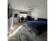 Spacious bedroom with a modern ceiling fan, a desk, and a large window at 2311 E Colter St, Phoenix, AZ 85016