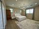 This primary bedroom showcases a contemporary chandelier, neutral walls, and wood-look flooring at 2311 E Colter St, Phoenix, AZ 85016