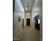 Bright hallway featuring sleek flooring, modern lighting, and a glimpse into a stylishly decorated living space at 2311 E Colter St, Phoenix, AZ 85016