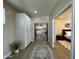 Hallway with built-in storage leads to the kitchen and bedroom with a bright view at 2311 E Colter St, Phoenix, AZ 85016