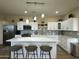 Bright kitchen features an island, white cabinetry, stainless steel appliances, and barstool seating at 2311 E Colter St, Phoenix, AZ 85016