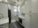 Bright laundry room with white cabinets and countertops at 2311 E Colter St, Phoenix, AZ 85016
