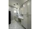 Functional laundry room with plenty of counter space, storage cabinets, and modern appliances at 2311 E Colter St, Phoenix, AZ 85016