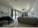Spacious living room features a grand piano, plush sofa, and sliding doors to the pool at 2311 E Colter St, Phoenix, AZ 85016