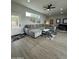 Spacious living room features a plush sectional sofa, modern decor, light wood flooring, and an abundance of natural light at 2311 E Colter St, Phoenix, AZ 85016