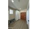 Functional mud room features white cabinets, a shoe rack bench, and a double wooden door for ample storage at 2311 E Colter St, Phoenix, AZ 85016