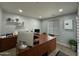 A modern office with a large wood desk, shelving, and natural lighting at 2311 E Colter St, Phoenix, AZ 85016