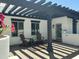 Cozy outdoor patio with comfortable seating under a shaded pergola, offering a relaxing retreat at 2311 E Colter St, Phoenix, AZ 85016