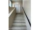 Bright stairway with wooden steps, neutral walls, and a sleek black handrail leading to the upper level at 2311 E Colter St, Phoenix, AZ 85016