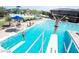 Community pool with diving boards and swimmers enjoying the sunny day at 3549 W Magellan Dr, Anthem, AZ 85086