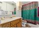Bathroom with mirrored vanity, a unique sink and toilet, and a vibrant shower curtain at 4501 E Carol Ave # 48, Mesa, AZ 85206