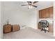 Bedroom featuring a ceiling fan, desk, and built-in cabinets for ample storage space at 4501 E Carol Ave # 48, Mesa, AZ 85206