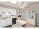 Well-lit kitchen with white cabinetry, tile flooring, and modern appliances at 4501 E Carol Ave # 48, Mesa, AZ 85206