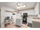 Bright kitchen with white cabinets, tile floors, a skylight, and modern appliances at 4501 E Carol Ave # 48, Mesa, AZ 85206