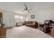 Inviting living room featuring neutral carpet, ceiling fan, and ample natural light at 4501 E Carol Ave # 48, Mesa, AZ 85206
