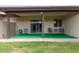 View of the unit's covered patio with artificial grass and outdoor seating at 4501 E Carol Ave # 48, Mesa, AZ 85206