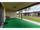 Unit's private outdoor patio with artificial turf, seating, and view of the common area at 4501 E Carol Ave # 48, Mesa, AZ 85206