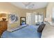 Serene bedroom with a blue comforter, soft lighting, and a ceiling fan at 6088 E Knolls N Way, Cave Creek, AZ 85331