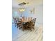 Bright dining room featuring a rustic wood table with seating for six under a modern chandelier at 7357 W Cheryl Dr, Peoria, AZ 85345