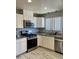 Well-lit kitchen featuring granite countertops, stainless steel appliances, and white cabinets at 7357 W Cheryl Dr, Peoria, AZ 85345