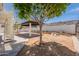 Expansive backyard featuring a covered patio, mature tree, and a stylish spiral staircase for outdoor enjoyment at 2701 E Caldwell St, Phoenix, AZ 85042