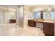 Luxury bathroom featuring double sinks, ample counter space, and a glass-enclosed shower for a spa-like experience at 2701 E Caldwell St, Phoenix, AZ 85042