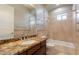 Full bathroom with a granite countertop vanity, tub, and shower at 2701 E Caldwell St, Phoenix, AZ 85042