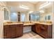 Elegant bathroom with double vanities, a spacious mirror, and recessed lighting for a bright and modern feel at 2701 E Caldwell St, Phoenix, AZ 85042