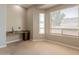 Well-lit bedroom with a built-in desk and a large window, offering a comfortable and functional space at 2701 E Caldwell St, Phoenix, AZ 85042