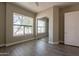 Sunlit bedroom with wood-look tile floors, large windows, and a closet at 2701 E Caldwell St, Phoenix, AZ 85042