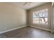 Bedroom with wood-look tile flooring and a large window with views at 2701 E Caldwell St, Phoenix, AZ 85042
