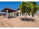 Back exterior featuring a covered patio, tiled roof, spiral staircase and desert landscaping providing a private outdoor retreat at 2701 E Caldwell St, Phoenix, AZ 85042