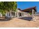 Stunning exterior with a covered patio, tiled roof, spiral staircase and desert landscaping providing a private outdoor retreat at 2701 E Caldwell St, Phoenix, AZ 85042