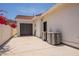 View of the house exterior featuring a garage and air conditioning units at 2701 E Caldwell St, Phoenix, AZ 85042