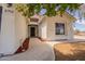 Welcoming entrance showcasing the front door with a walkway, garden and arched entrance at 2701 E Caldwell St, Phoenix, AZ 85042