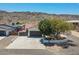 Charming single-Gathering home boasts a desert landscaped yard and convenient two-car garage at 2701 E Caldwell St, Phoenix, AZ 85042