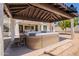 Backyard hot tub under a wooden pergola with a spiral staircase and ample patio space at 2701 E Caldwell St, Phoenix, AZ 85042