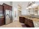 Kitchen showcasing stainless steel refrigerator, granite countertop and dark wood cabinets at 2701 E Caldwell St, Phoenix, AZ 85042