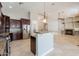 Open-concept kitchen features an eat-in bar, dark cabinets, stainless steel appliances, and open floor plan at 2701 E Caldwell St, Phoenix, AZ 85042