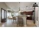 Spacious kitchen with a bar and breakfast nook features dark wood cabinetry and tile floors at 2701 E Caldwell St, Phoenix, AZ 85042