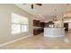 Spacious kitchen and adjacent living area filled with natural light from a large window at 2701 E Caldwell St, Phoenix, AZ 85042