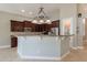 Bright kitchen features dark cabinetry, stone countertops, recessed lights and stainless steel refrigerator at 2701 E Caldwell St, Phoenix, AZ 85042