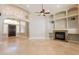 Bright living area featuring tile floors, fireplace, built-in shelves, and an open layout great for entertaining at 2701 E Caldwell St, Phoenix, AZ 85042