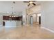 Open floor plan showcasing the living room with tile flooring, high ceilings, and seamless connection to kitchen at 2701 E Caldwell St, Phoenix, AZ 85042