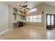 Inviting living room with a fireplace, ceiling fan and large windows providing natural light at 2701 E Caldwell St, Phoenix, AZ 85042